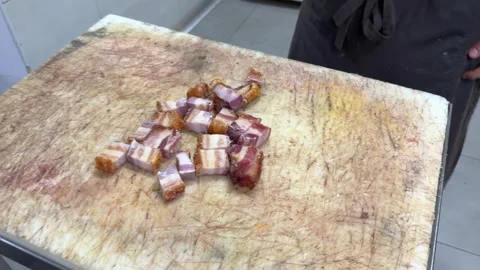 Chef cutting crispy pork belly and deep frying croquettes 動画素材 344100196