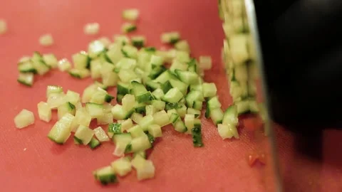 Chef cutting cucumber with a knife on cutting board Stock Footage 148246567