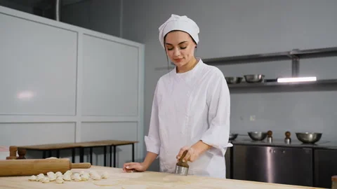Chef Cutting Dough Circles for Dumplings Stock Footage 299657357