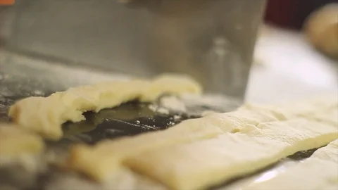 Chef is cutting the dough to prepare some homemade noodles Stock Footage 94953830