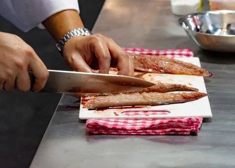 Chef cutting fish, Chef slices fish fresh on Board in the kitchen Stock Photos