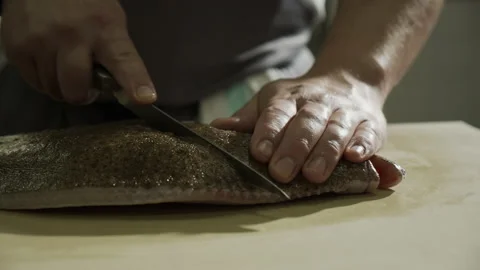 Chef is cutting of fish head  스톡 동영상 163317168