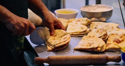 Chef cutting flatbread with pizza cutter, commercial kitchen 库存影片 343059953