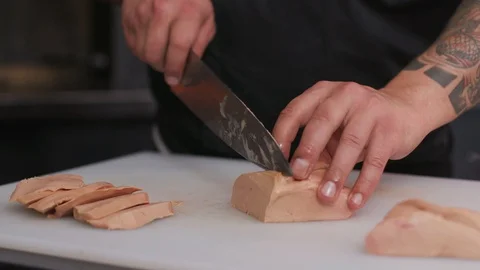 Chef cutting foie gras with a knife raw lunch condiment preparation freshness Stock Footage 103288221