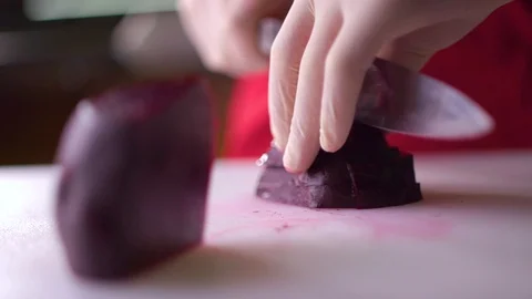 Chef cutting fresh beetroot vegetable on a white background Stock Footage 119300357