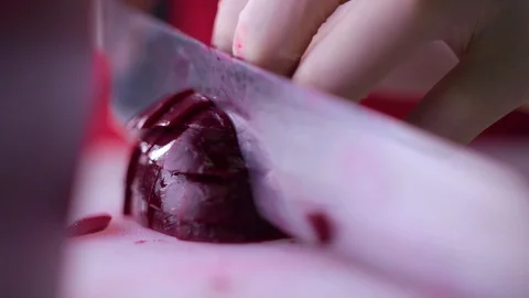 Chef cutting fresh beetroot vegetable on a white background Stock Footage 119300358