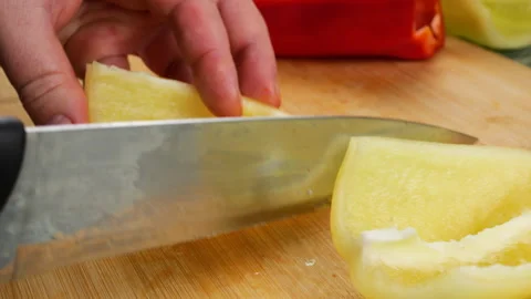 	Chef cutting fresh bell pepper on a wooden board.  動画素材 341527749
