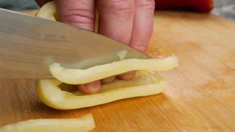 Chef cutting fresh bell pepper on a wooden board. Video stock 341531068