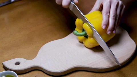Chef cutting fresh bell yellow peppers Stock Footage 128316797