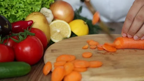 Chef Cutting Fresh Carrot on Chopping Board Видео 343745562