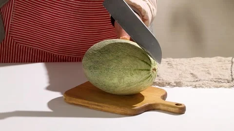 Chef Cutting Fresh Hami Melon on Wooden Board Stock Footage 340268021