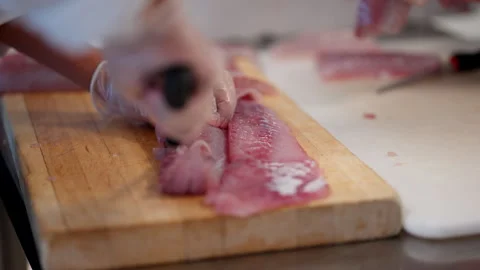 Chef Cutting Fresh Herring Fish On Wooden Chopping Board. - closeup shot Stock Footage 295049310