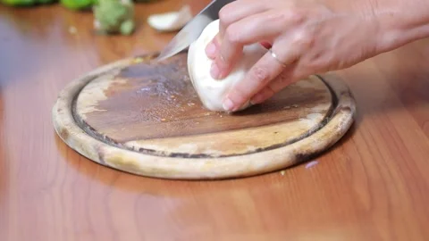 Chef cutting fresh mozzarella cheese on board Video stock 333844683