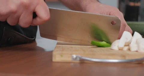 Chef cutting fresh pepper using axe. Male cooker making healthy vegetable meal Stock Footage 252386955