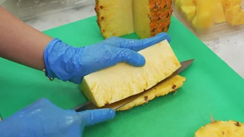Chef cutting fresh pineapple on green cutting board close up 스톡 동영상 343017662