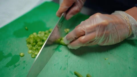 Chef cutting fresh vegetables by hand during food preparation training session Stock Footage 307979872