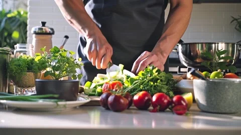 Chef cutting fresh vegetables in the kitchen Stock Footage 304534523