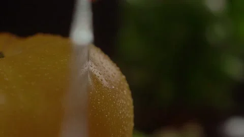 Chef cutting a fresh yellow tomato with a sharp steel knife into a slice Stock Footage 168819208