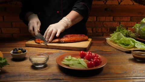 Chef cutting fried eel on a wooden board. Stock Footage 158852149