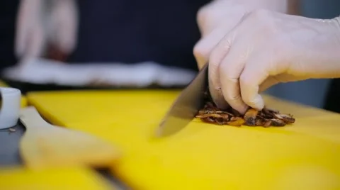 Chef cutting fried mushrooms close up Stock Footage 67864259