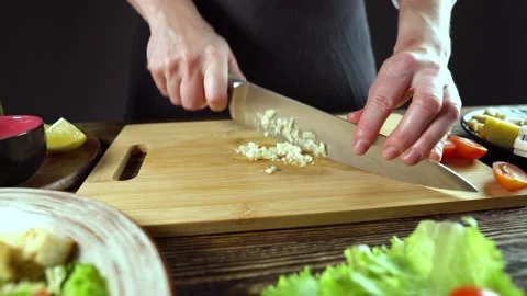 Chef is cutting the garlic. Process of cooking a appetizing delicious dish Stock Footage 176726309
