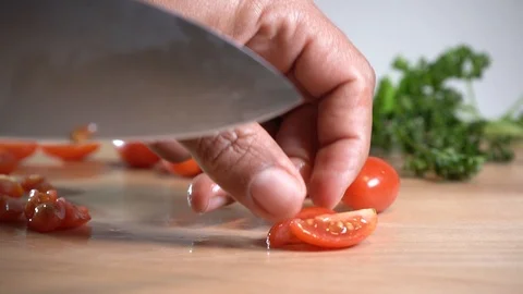 Chef cutting grape tomatos Stock Footage 124443331