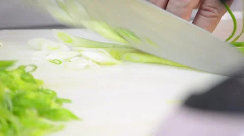 Chef Cutting Green Onions on Cutting Board in Kitchen Stock Footage 58103451