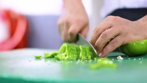 Chef cutting the green pepper with knife Stock Footage 152282124