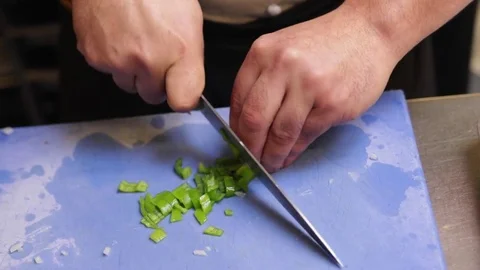 Chef cutting green peppers Stock Footage 72976080