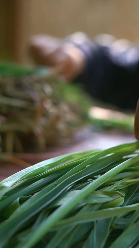 A chef is cutting greens on the table. Stock Footage 310376731