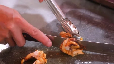 Chef cutting grilled shrimp on a flat-top grill Stock Footage 344218459