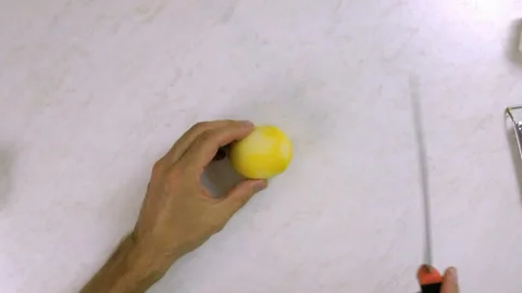 Chef cutting in half lemon. Making Lemon Mascarpone Pie Series. Stock Footage 98798793