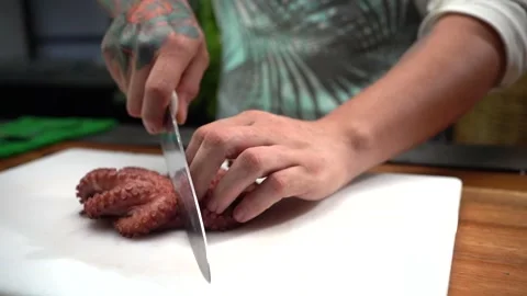 Chef cutting half octopus camera follow ... | Stock Video | Pond5