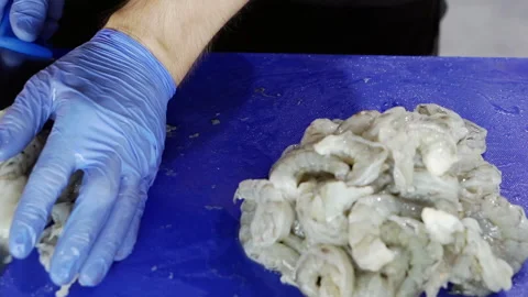 The chef is cutting the king prawns. Stock Footage 164588908