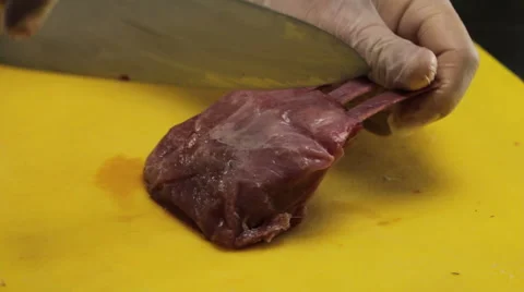 Chef cutting lamb ribs to grill it, close up Vidéo 66076739