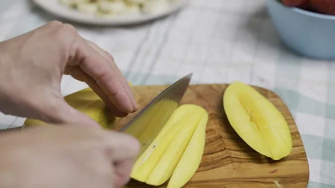 Chef cutting up Mango slice into squares on cutting board, closeup Stock Footage 341203685