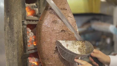 Chef cutting the meat doner with the sharp knife in street food restaurant Видео 144417103