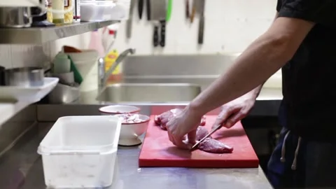 Chef cutting meat in the kitchen Stock Footage 137945773