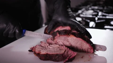 Chef cutting meat slices from large piece Видео 151406787