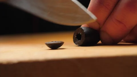 Chef cutting olives with a knife. Stock Footage 146860315