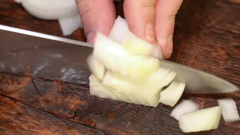 Chef cutting the onion at cutting board. Stock Footage 255125536