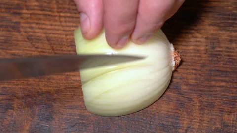 Chef cutting the onion at cutting board. High quality 4k footage Stock Footage 255599251