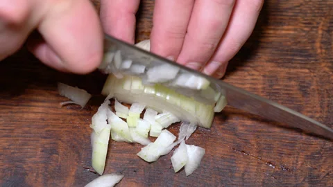 Chef cutting the onion at cutting board. High quality 4k footage Stock Footage 255599648