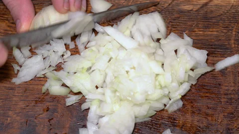 Chef cutting the onion at cutting board. High quality 4k footage Stock Footage 255599681