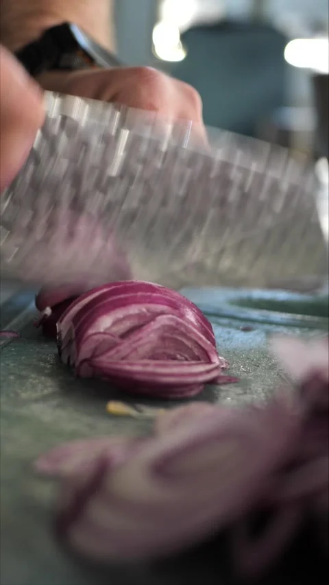 Chef cutting onion on cutting board in restaurant kitchen Stock Footage 306007926
