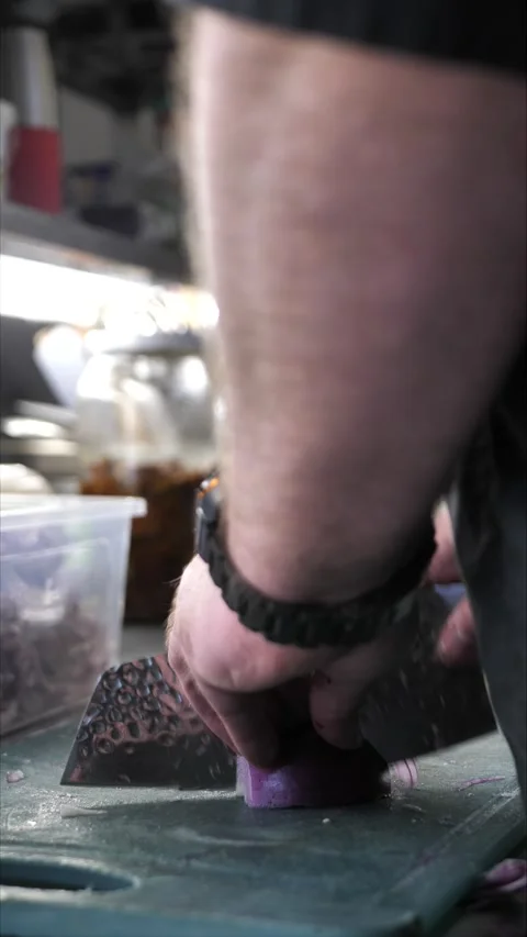 Chef cutting onion on cutting board in restaurant kitchen Stock Footage 306007935