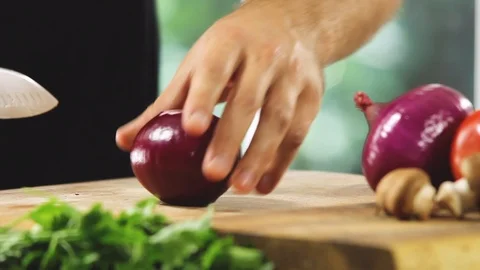 Chef is cutting onion in the kitchen Stock Footage 91013401