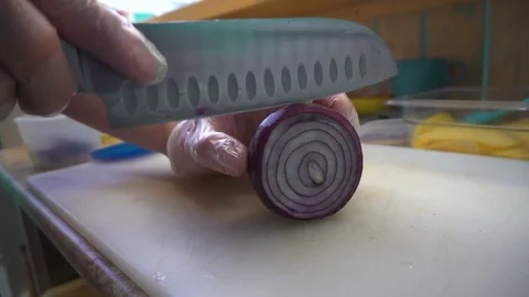 Chef cutting up an onion with a knife Stock Footage 73810366