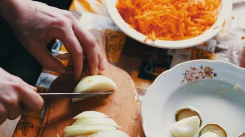 Chef cutting up an onion with a knife Stock Footage