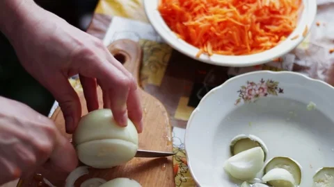 Chef cutting up an onion with a knife Stock Footage